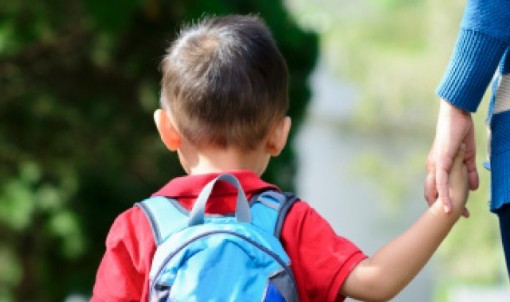 Child and mother walking hand in hand